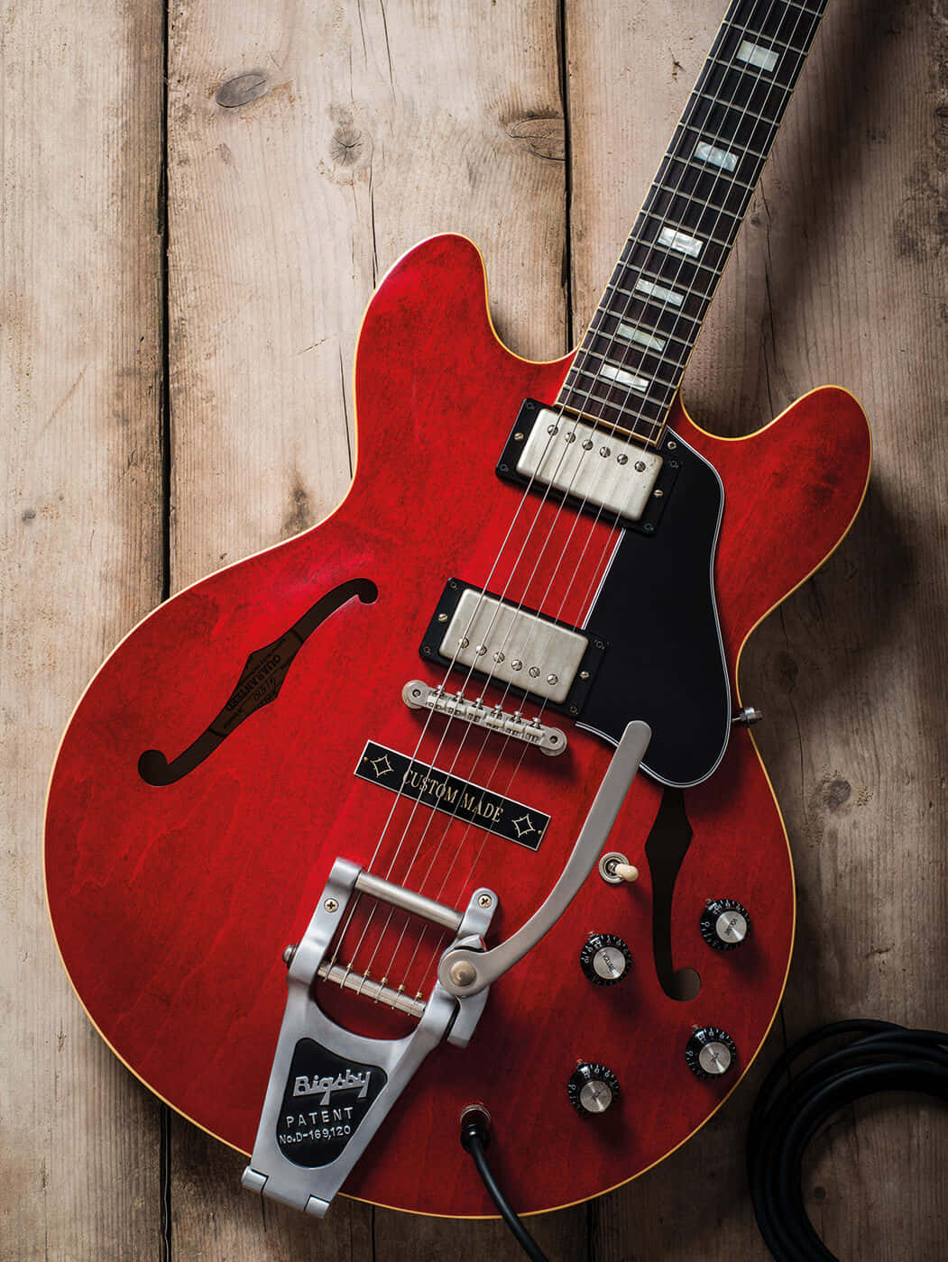 Gibson 335 On Wooden Surface Background