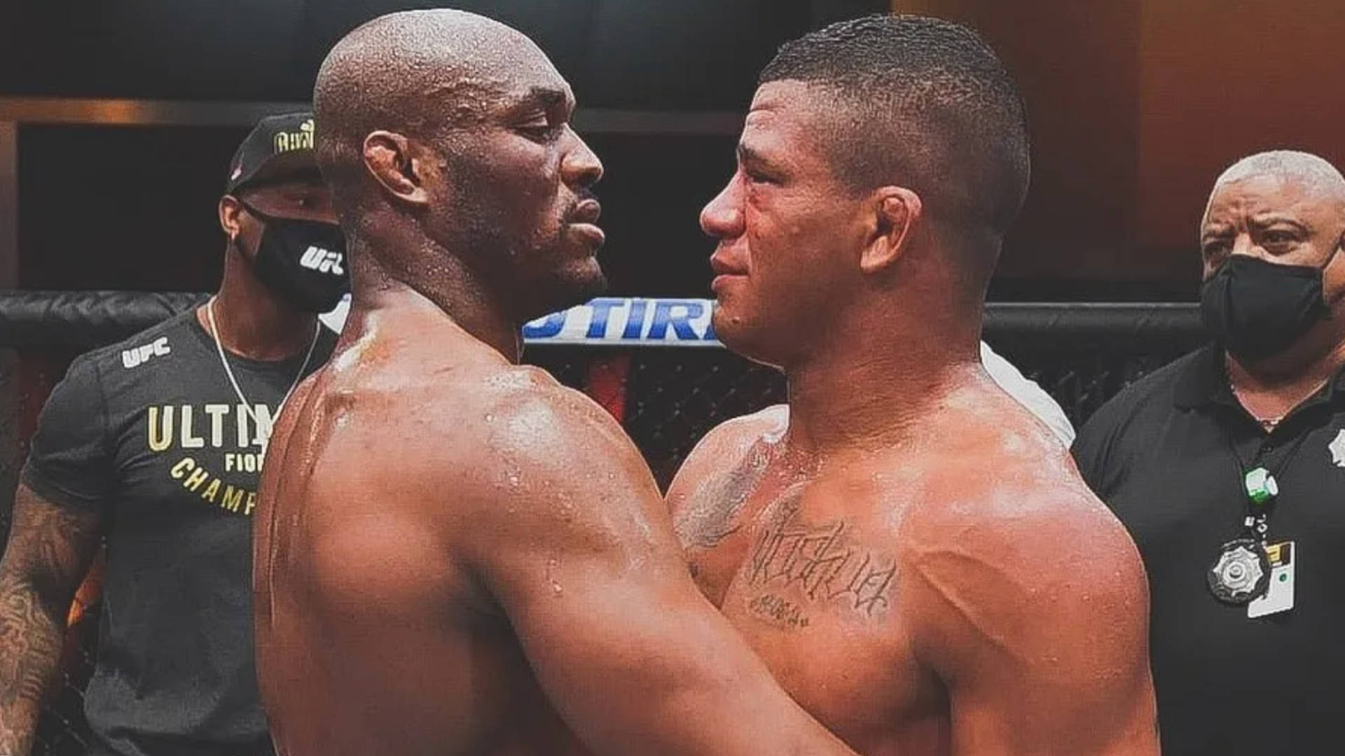 Gilbert Burns Emotionally Embracing Kamaru Usman Background