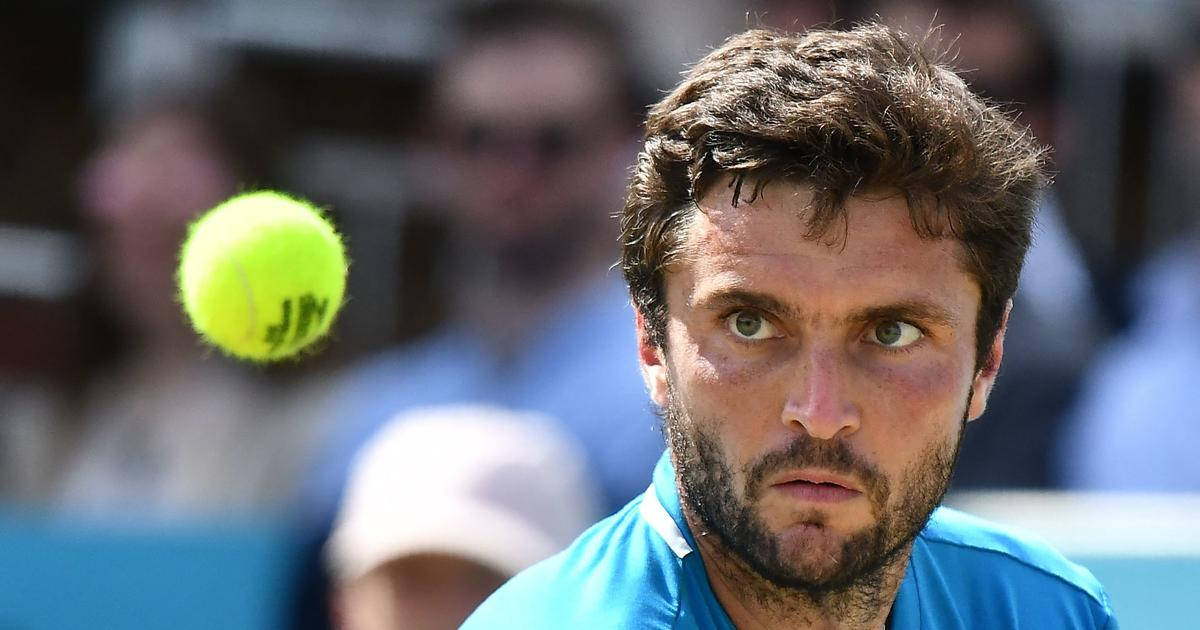 Gilles Simon Focused At Tennis Ball Background