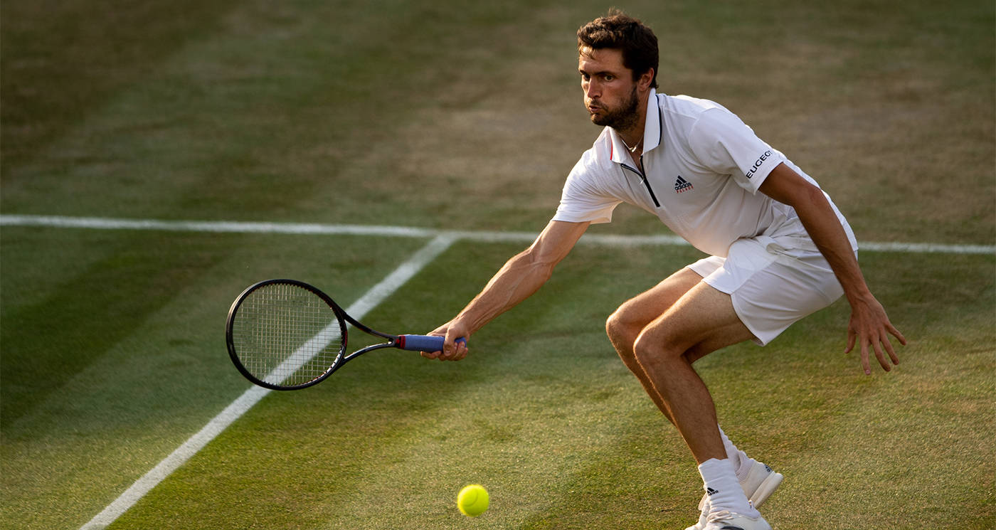 Gilles Simon Missing The Ball At Wimbledon Background