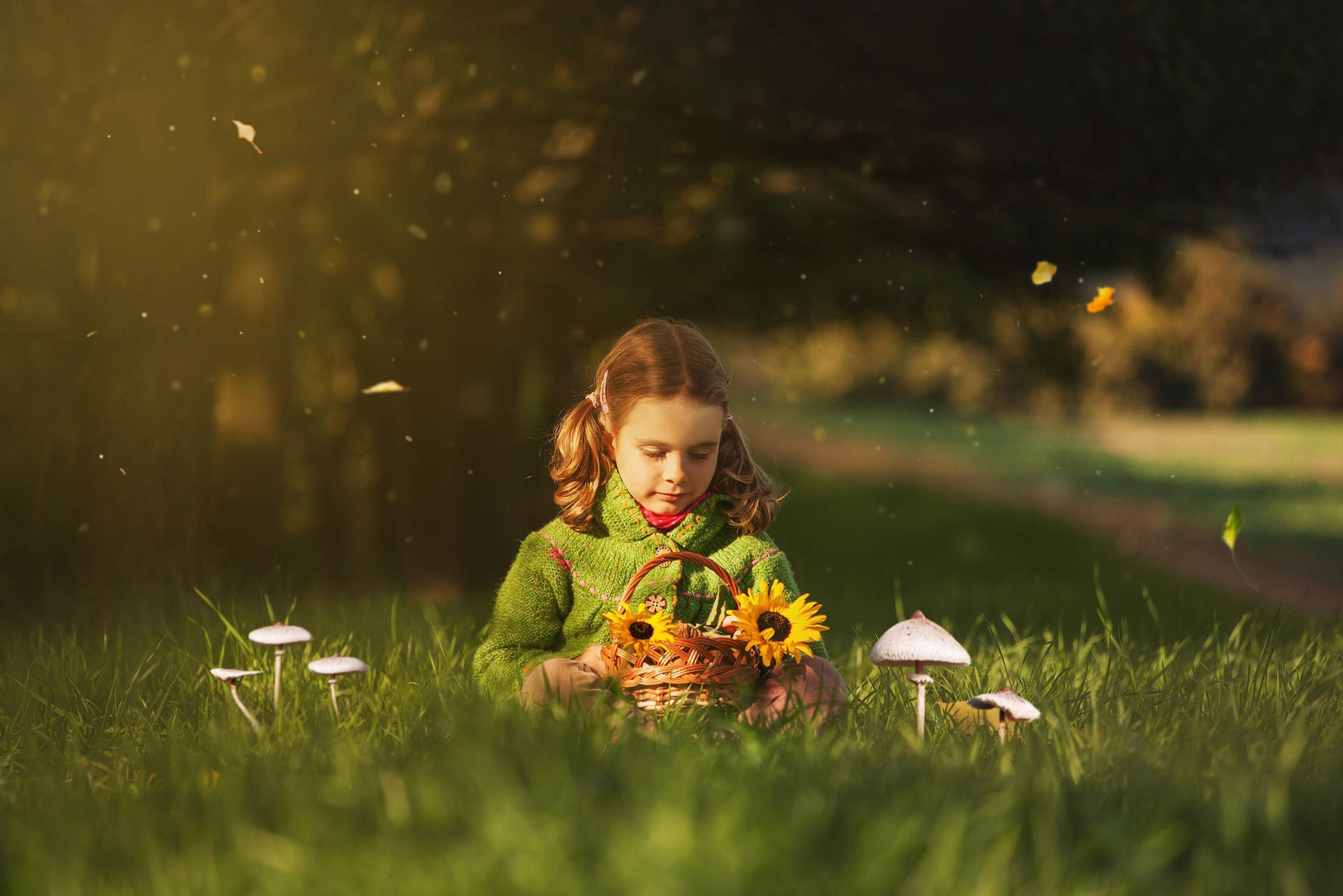 Girl Child Holding Sunflowers In Spring Background