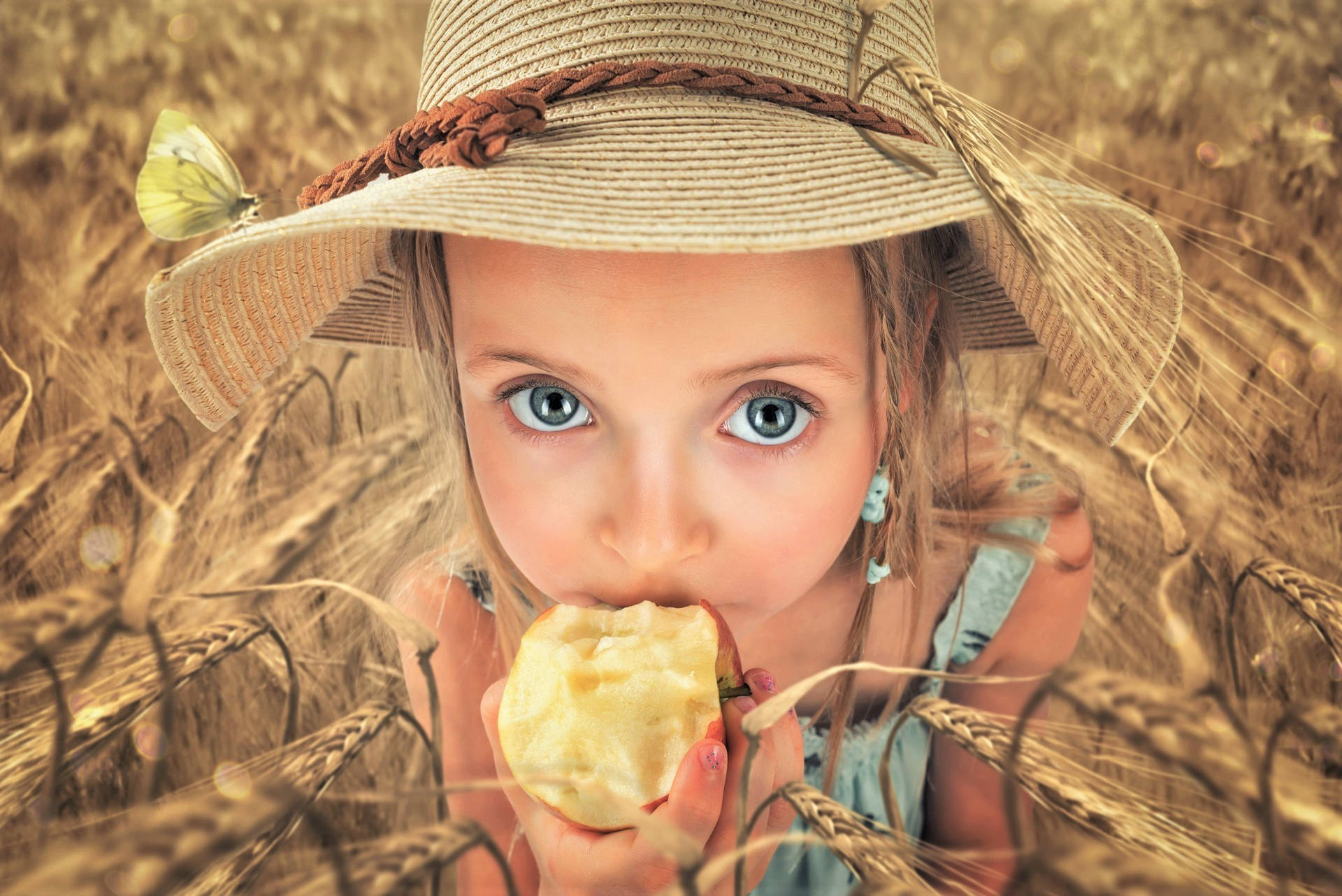 Girl Eating Apple In Wheat Field Background