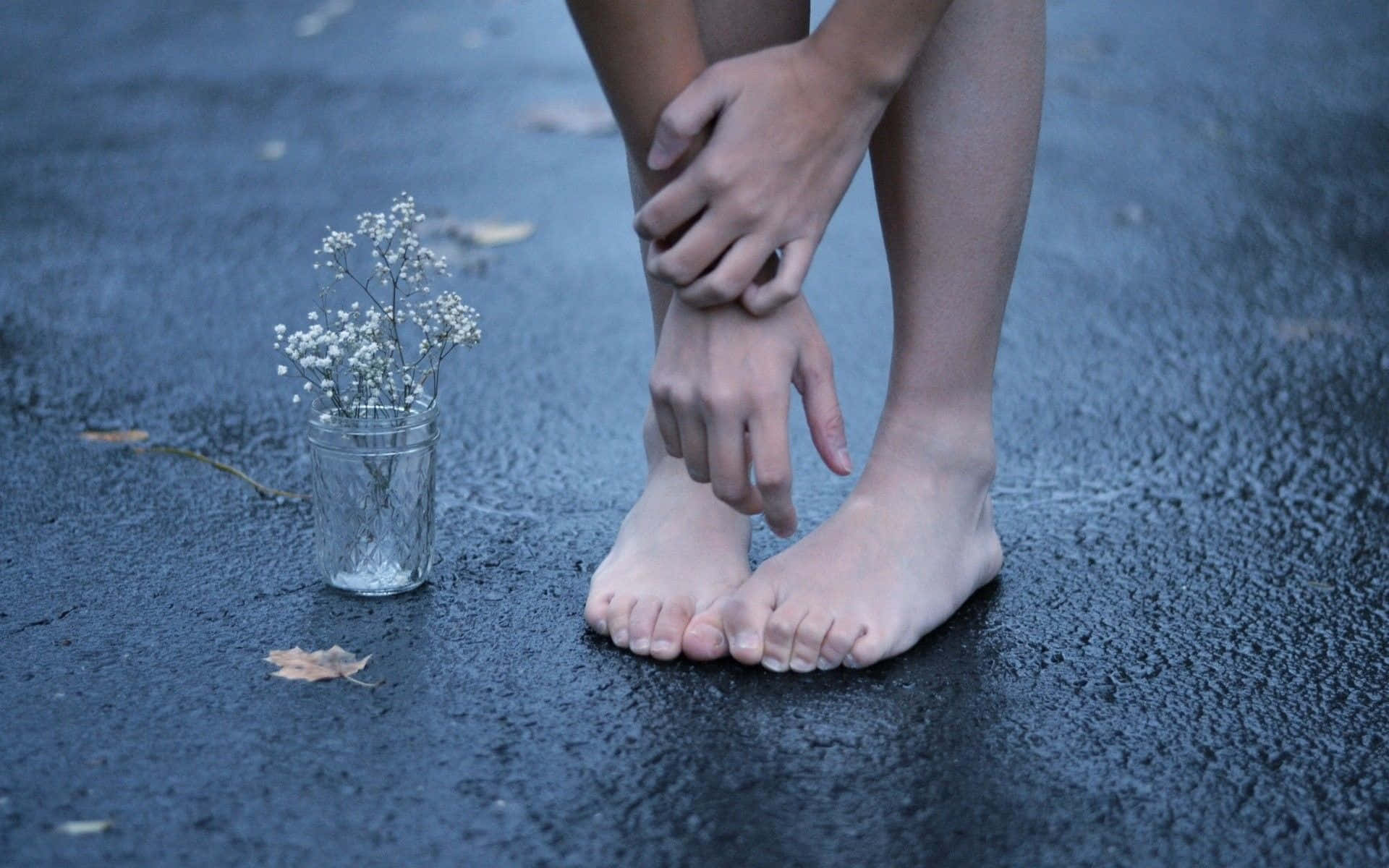 Girl Feet On The Road With Flowers Background