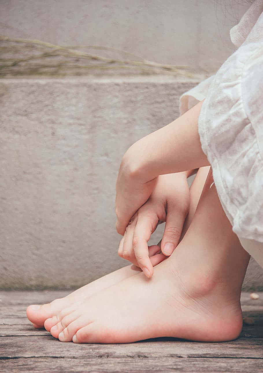 Girl Feet On Wooden Floor Background