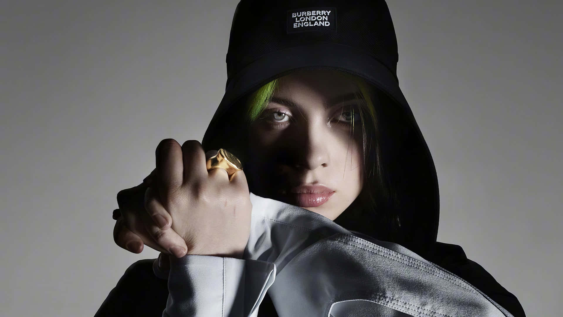 Girl Power! Billie Eilish Stands With Her Laptop Showing Her Influence And Success. Background