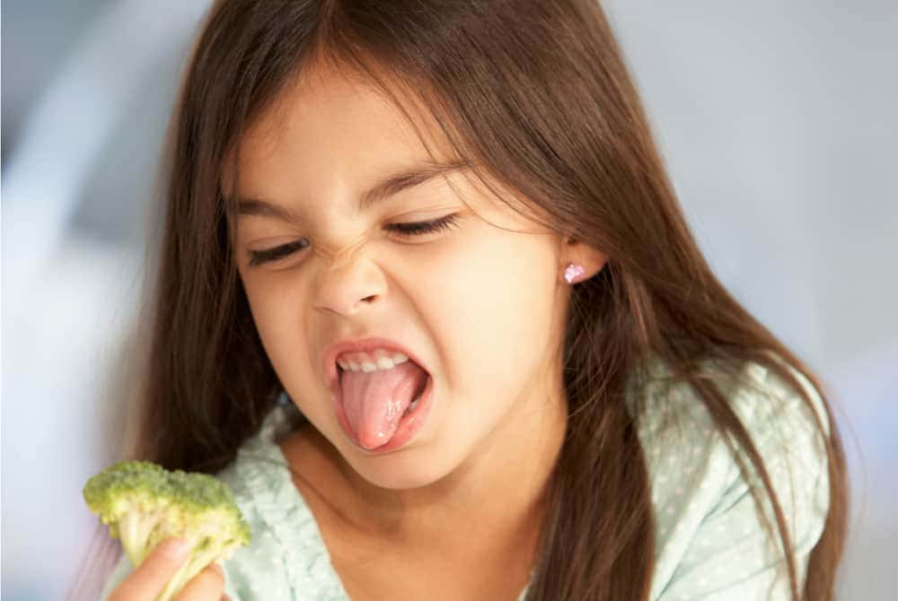 Girl Reluctant To Eat Broccoli
