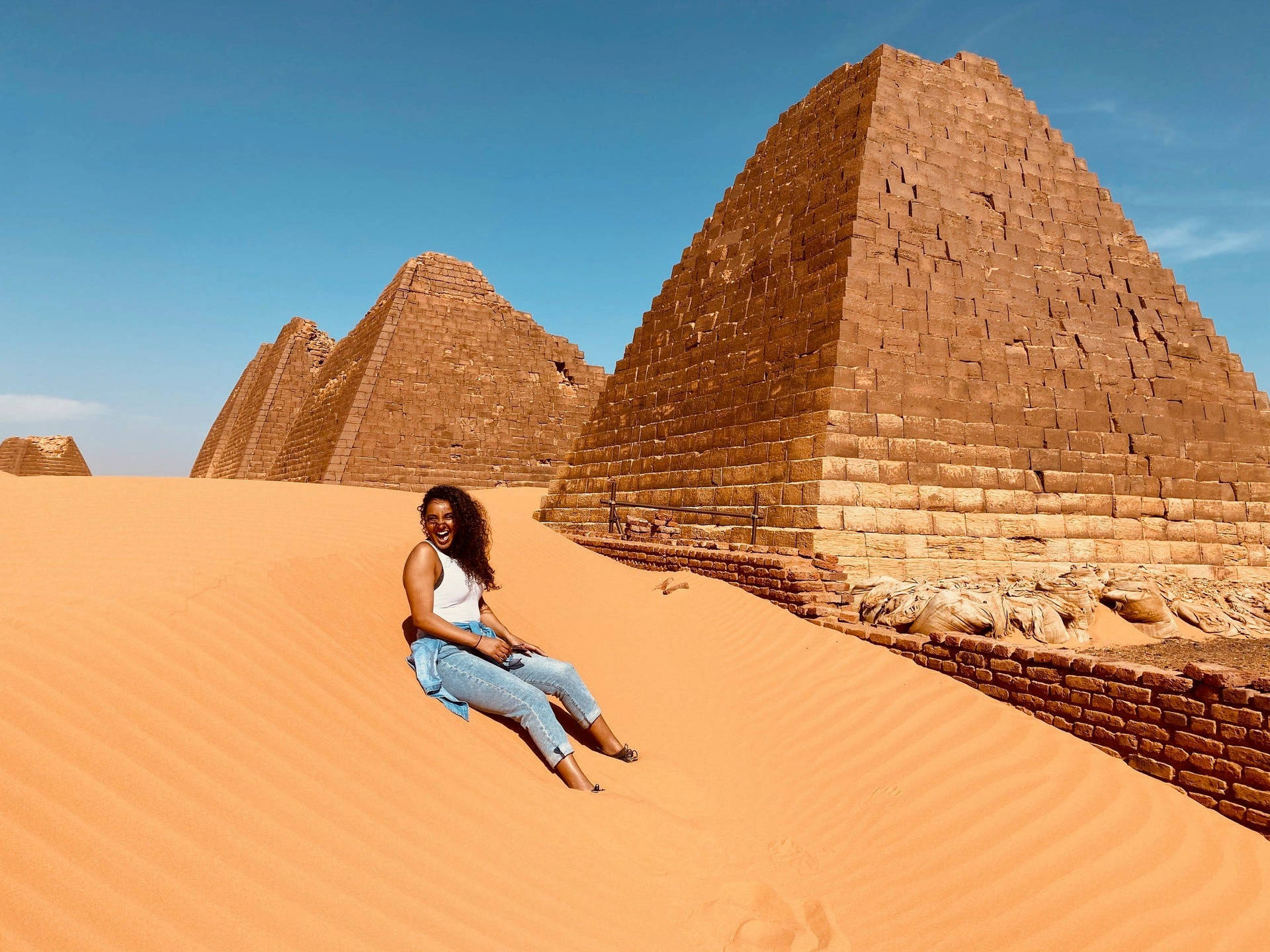 Girl Sitting In Sudan Desert Background