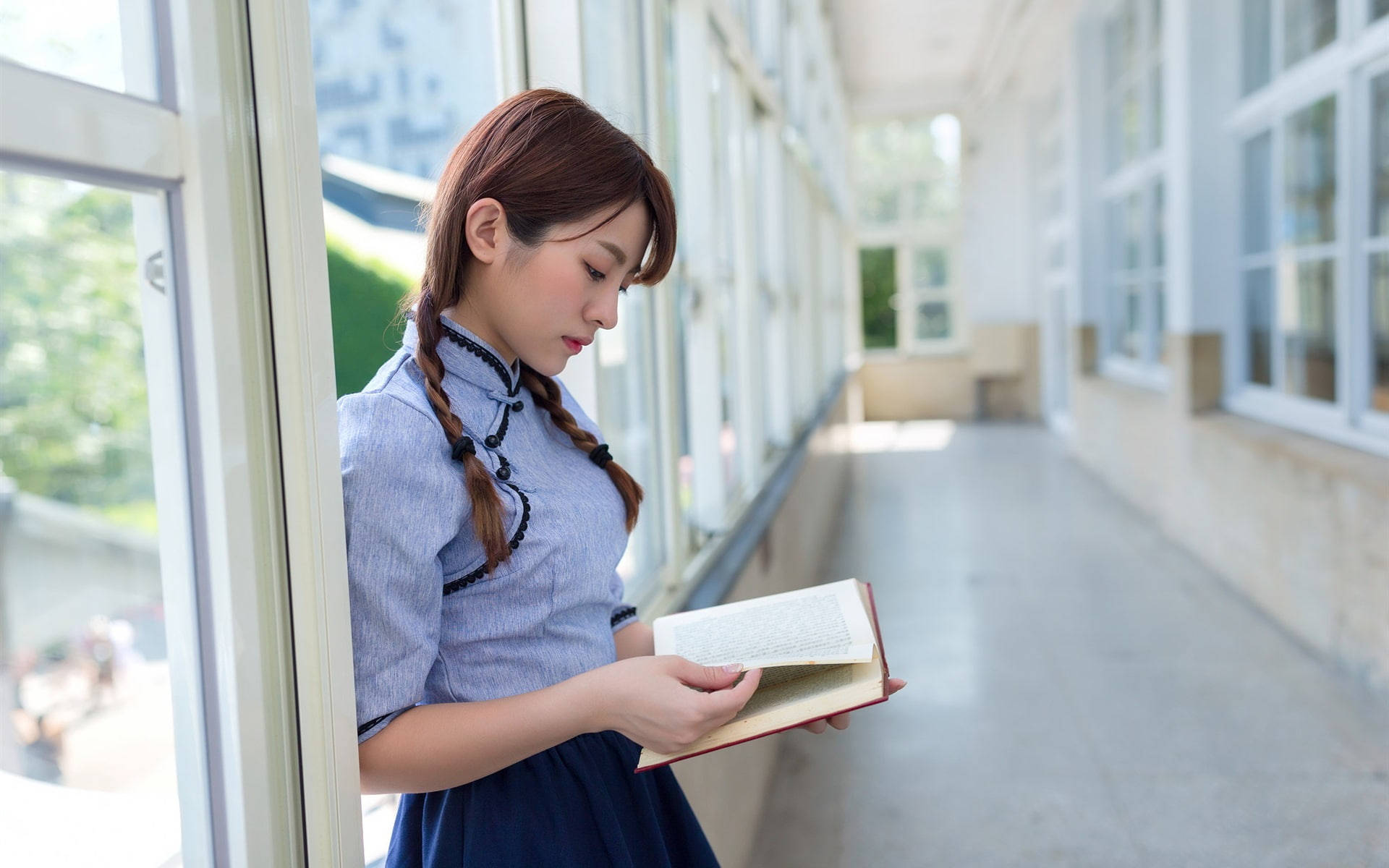 Girl Student Reading In Corridor