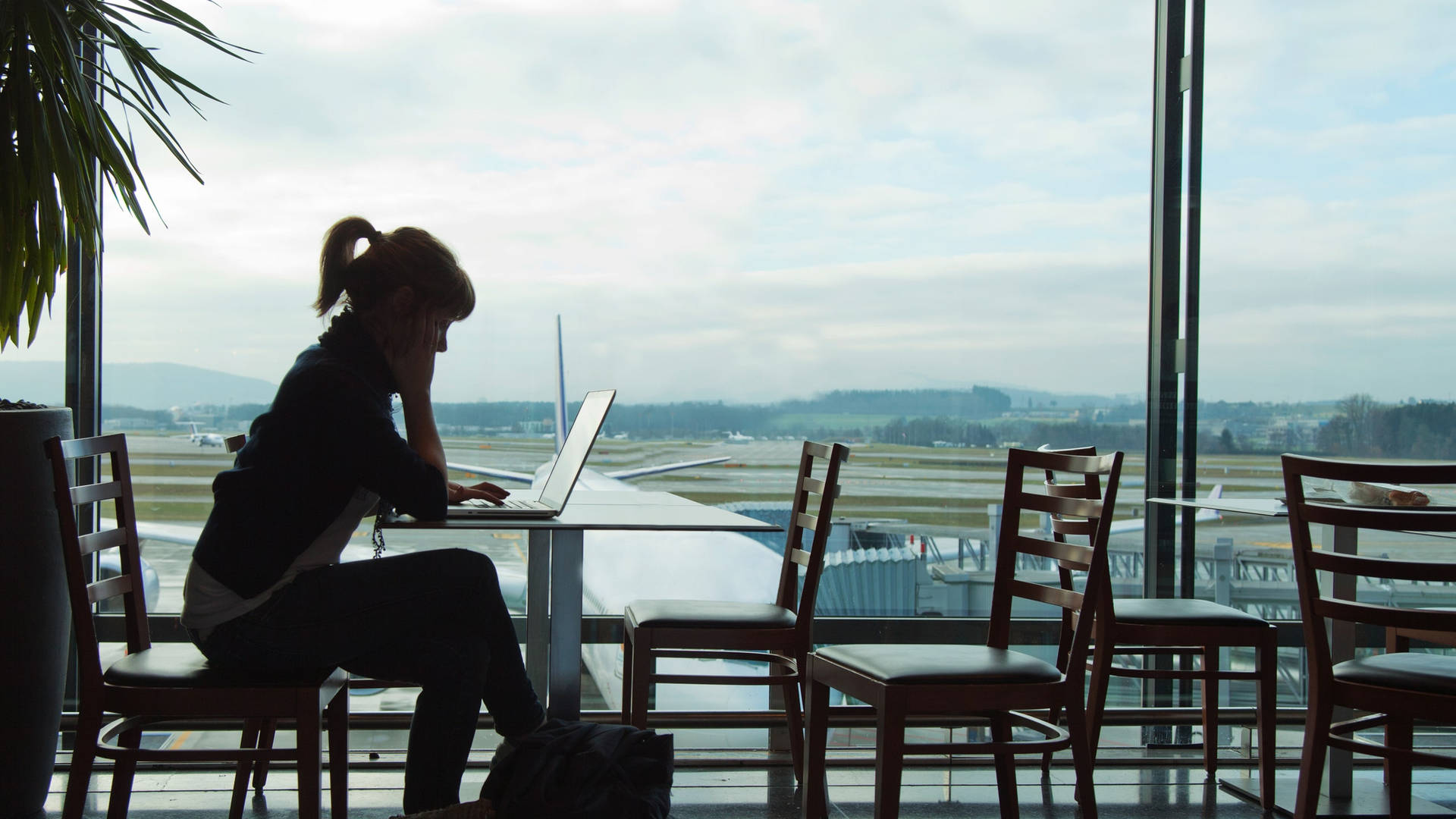 Girl Using A Travel Laptop Side View Shot Background