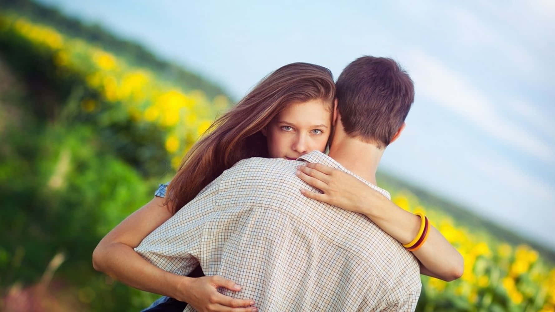 Girlfriend And Boyfriend In Flower Field Background