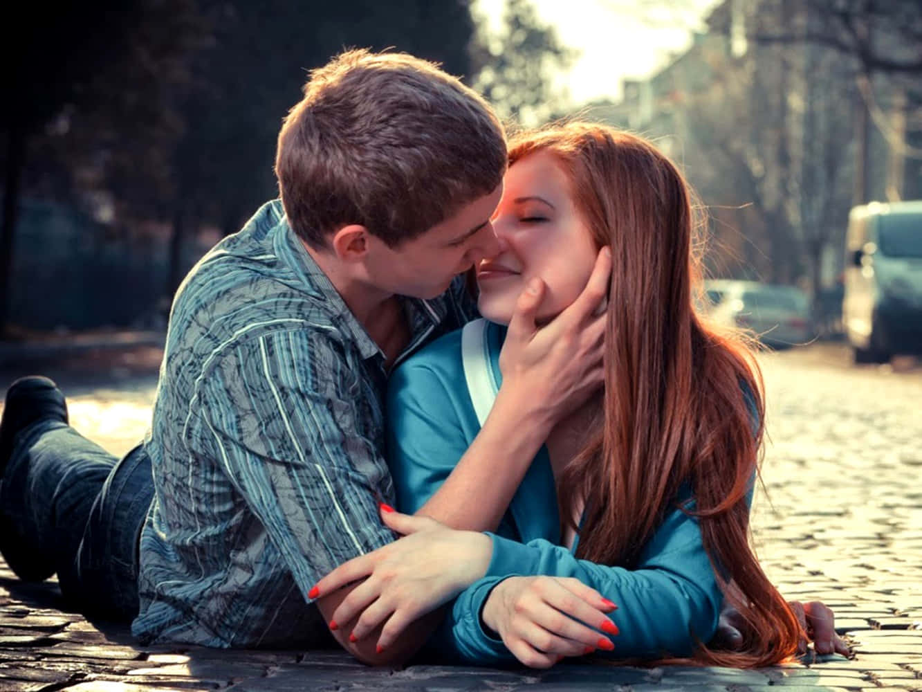 Girlfriend And Boyfriend Kissing On Pavement Background