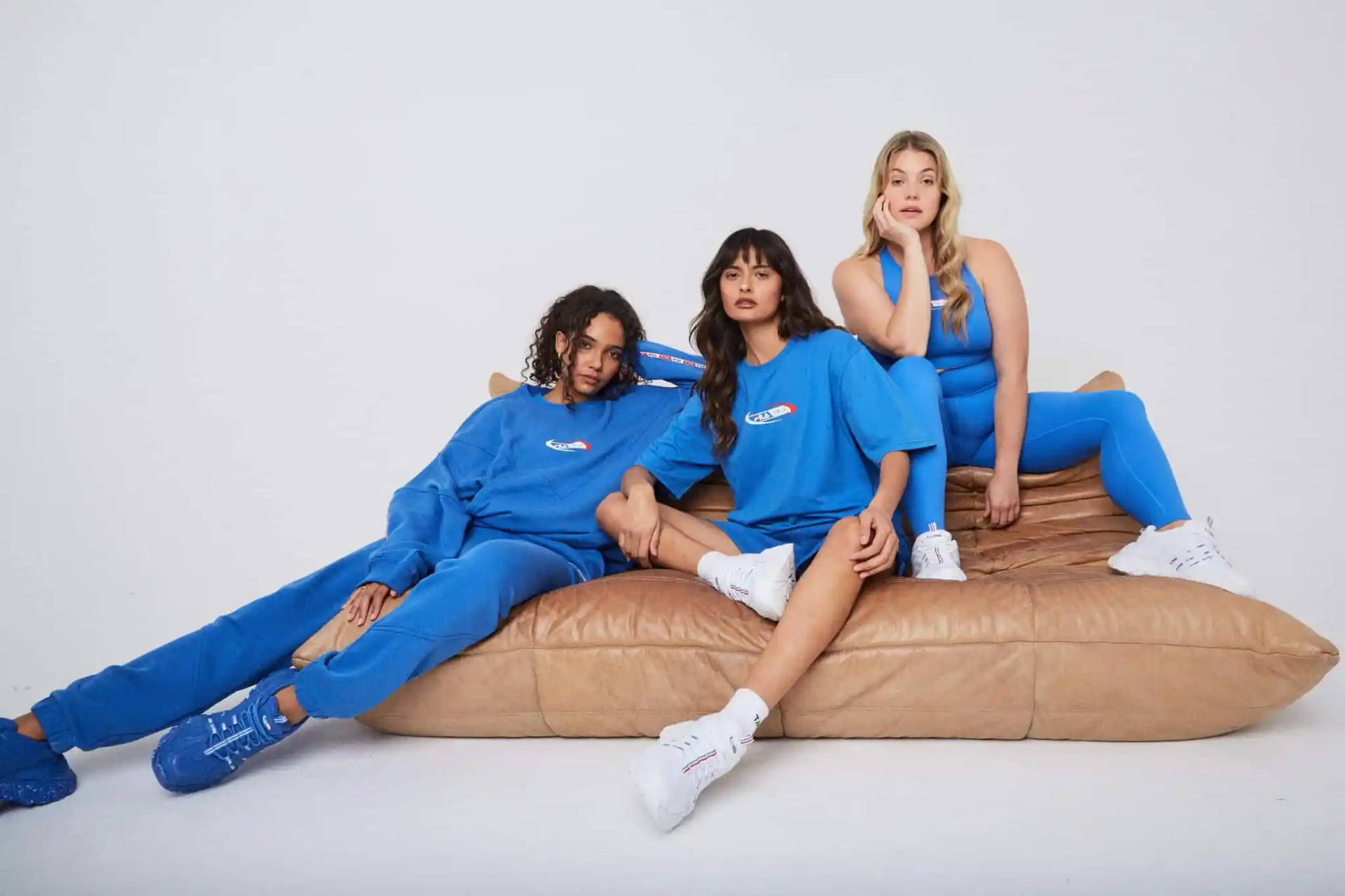 Girls In Blue Fila Couch Background