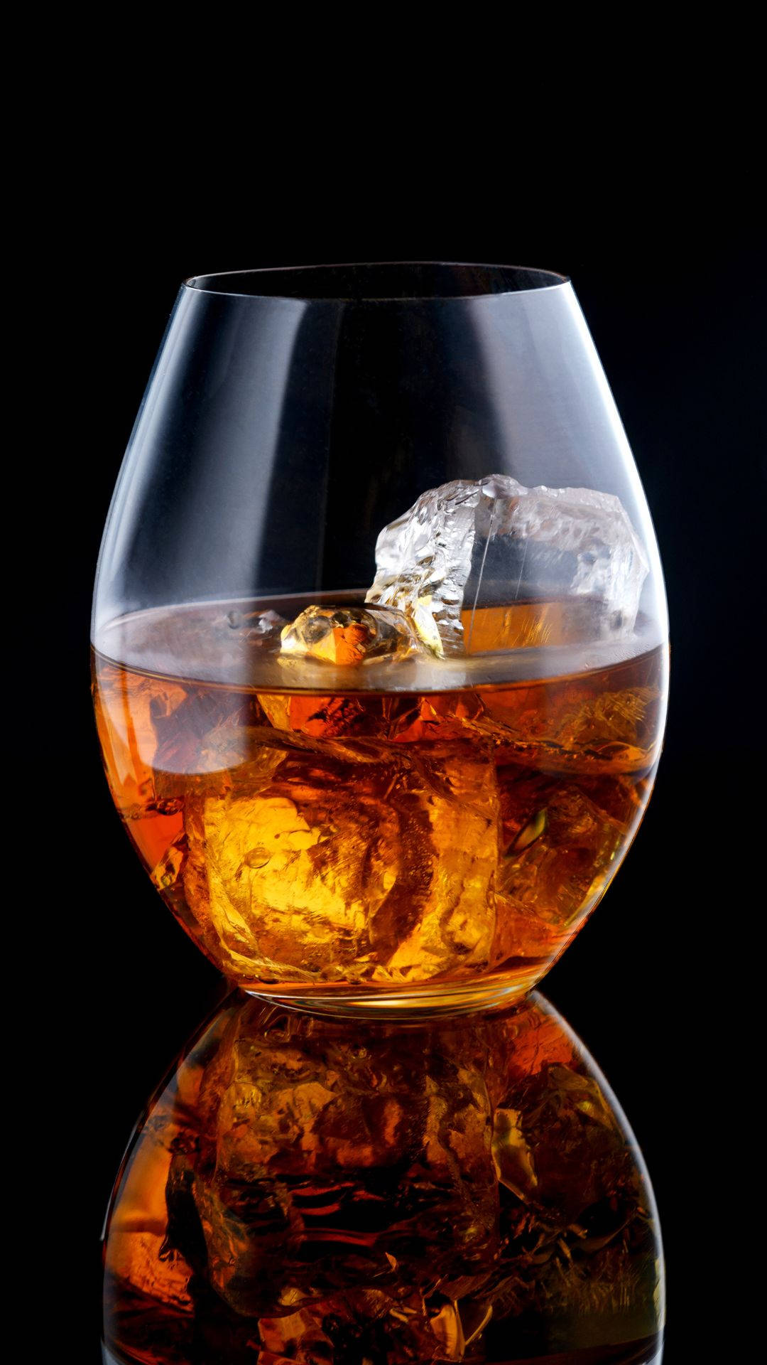 Glass Of Alcohol With Ice Reflection Background