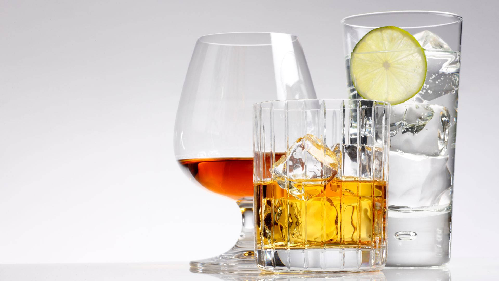 Glass Of Alcohol With Lime And Ice Background