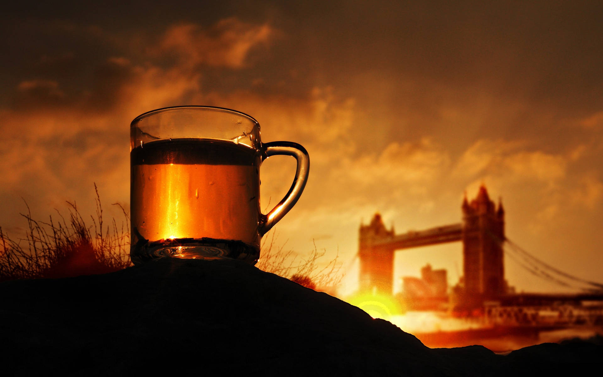 Glass Of Tea Against Sunset Skyline Background