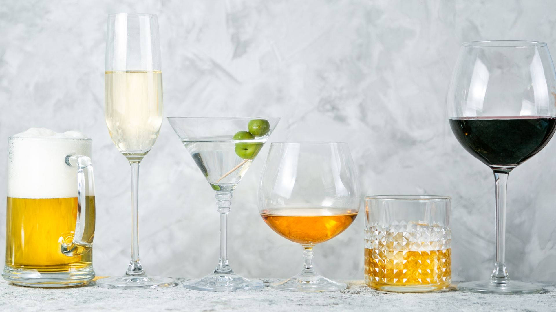 Glasses Of Alcohol On White Marble Background