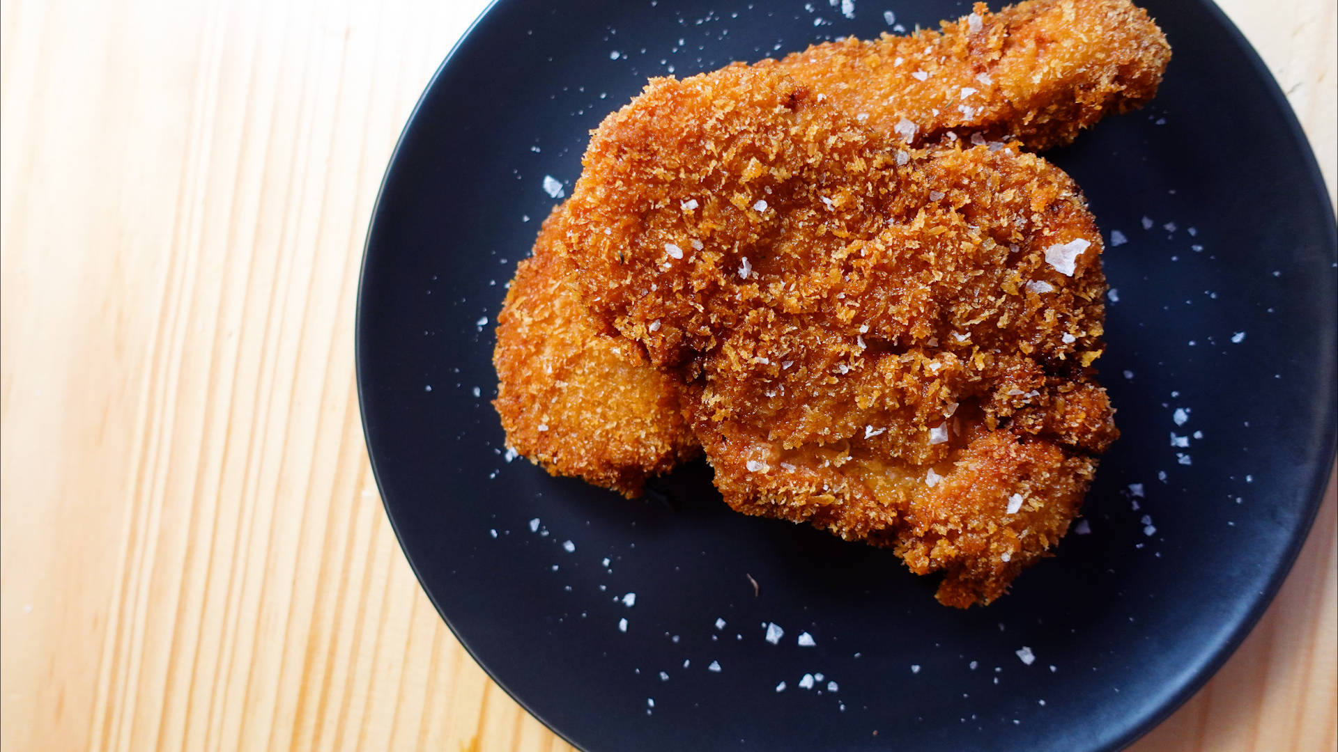 Glazed Tonkatsu On A Black Round Plate Background