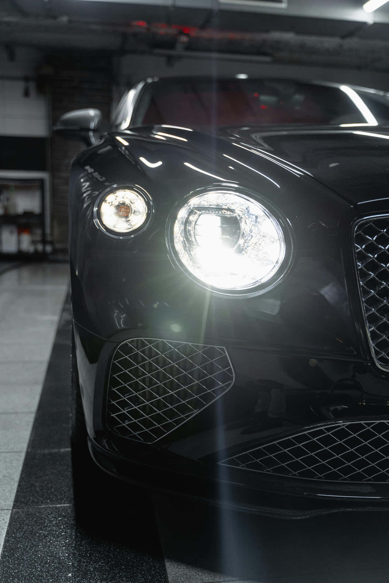 Gleaming Black Luxury Car Front View Background