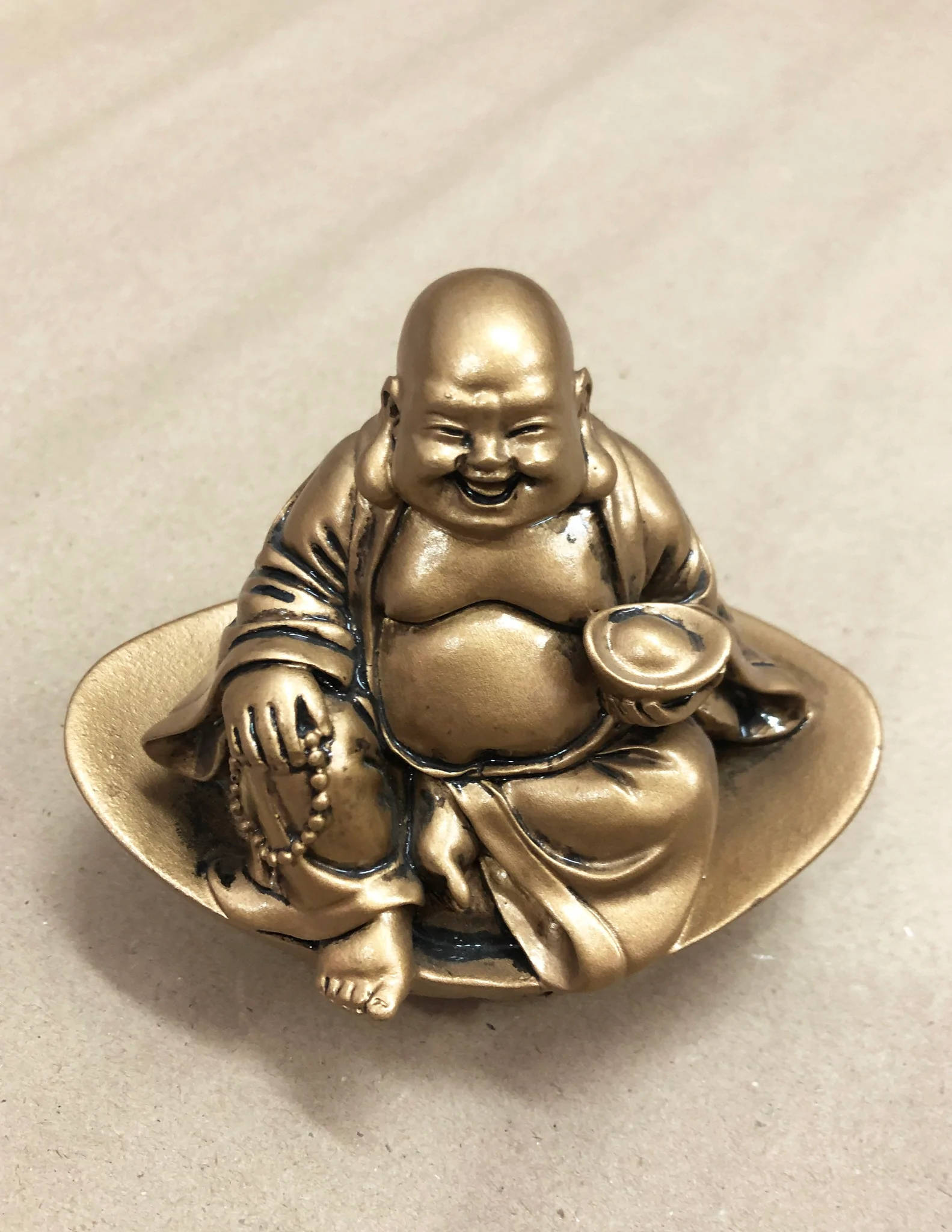 Gleaming Small Laughing Buddha Statue Background