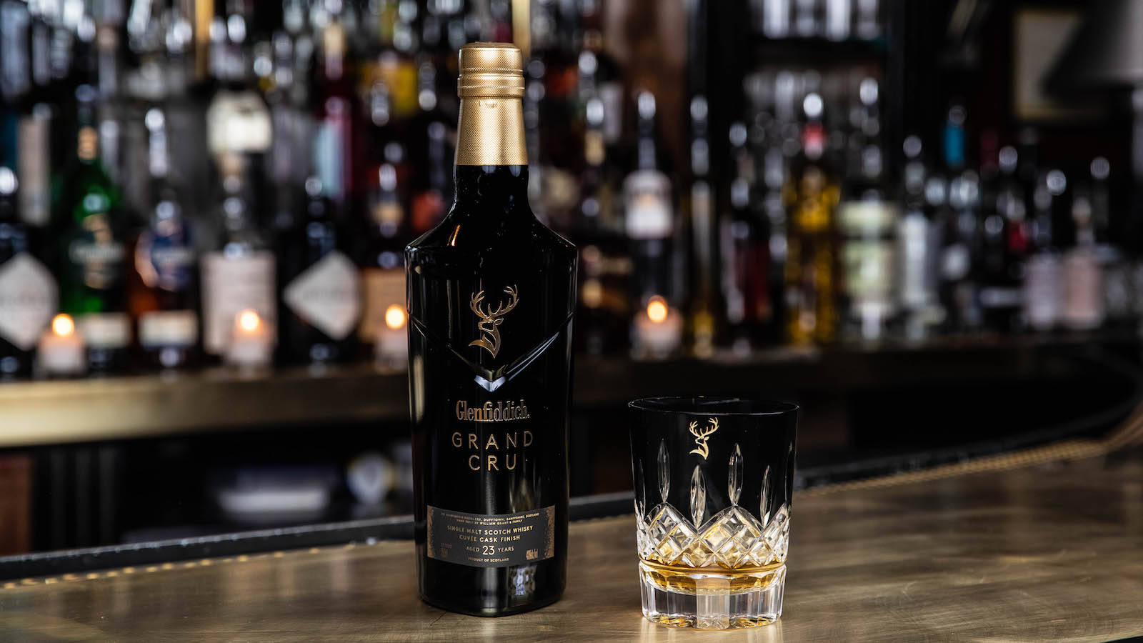 Glenfiddich Grand Cru With Matching Rocks Glass Background