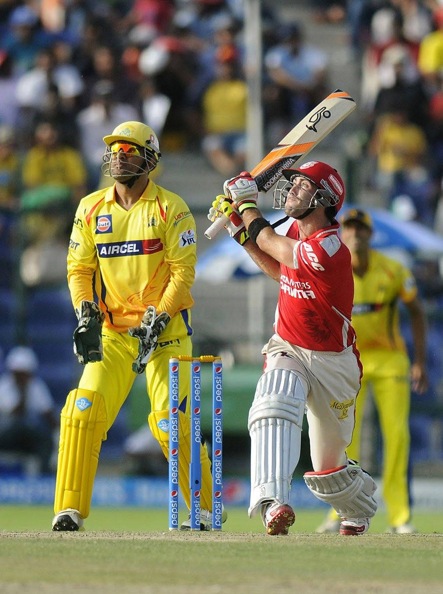 Glenn Maxwell In Action In Cricket Field Background