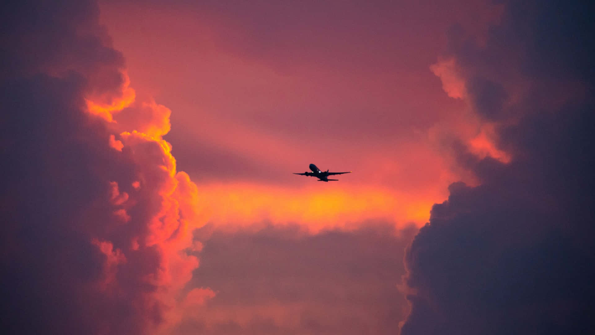 Gliding In The Sky With A Sleek And Vibrant Pink Plane Background