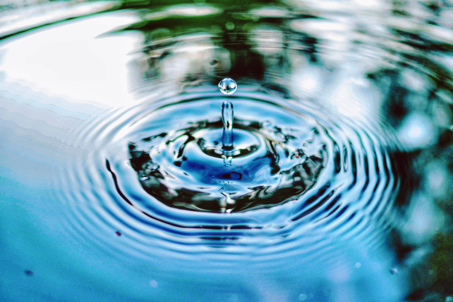 Glistening Droplet Creating Ripples Background