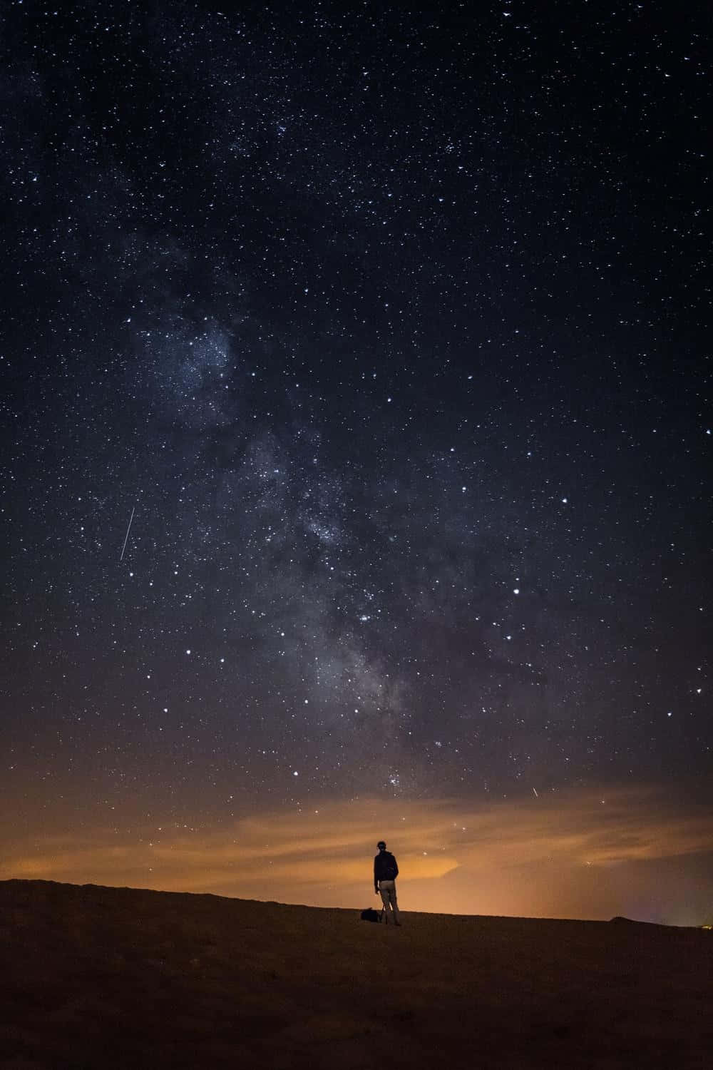 Glittering Blue Stars Shine Brightly Against A Dark Sky. Background