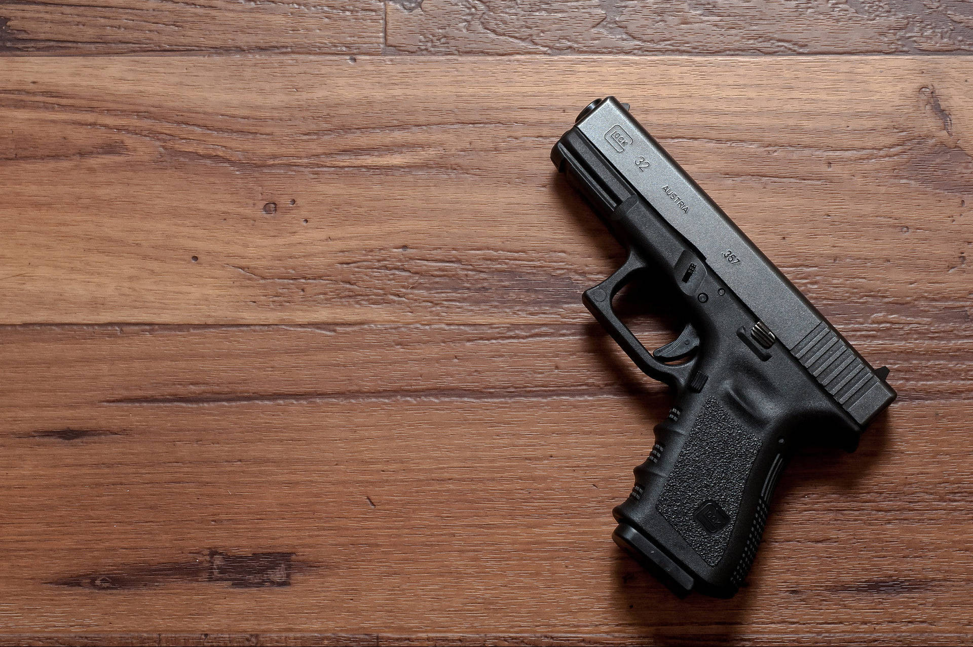 Glock 32 On Wooden Table Background