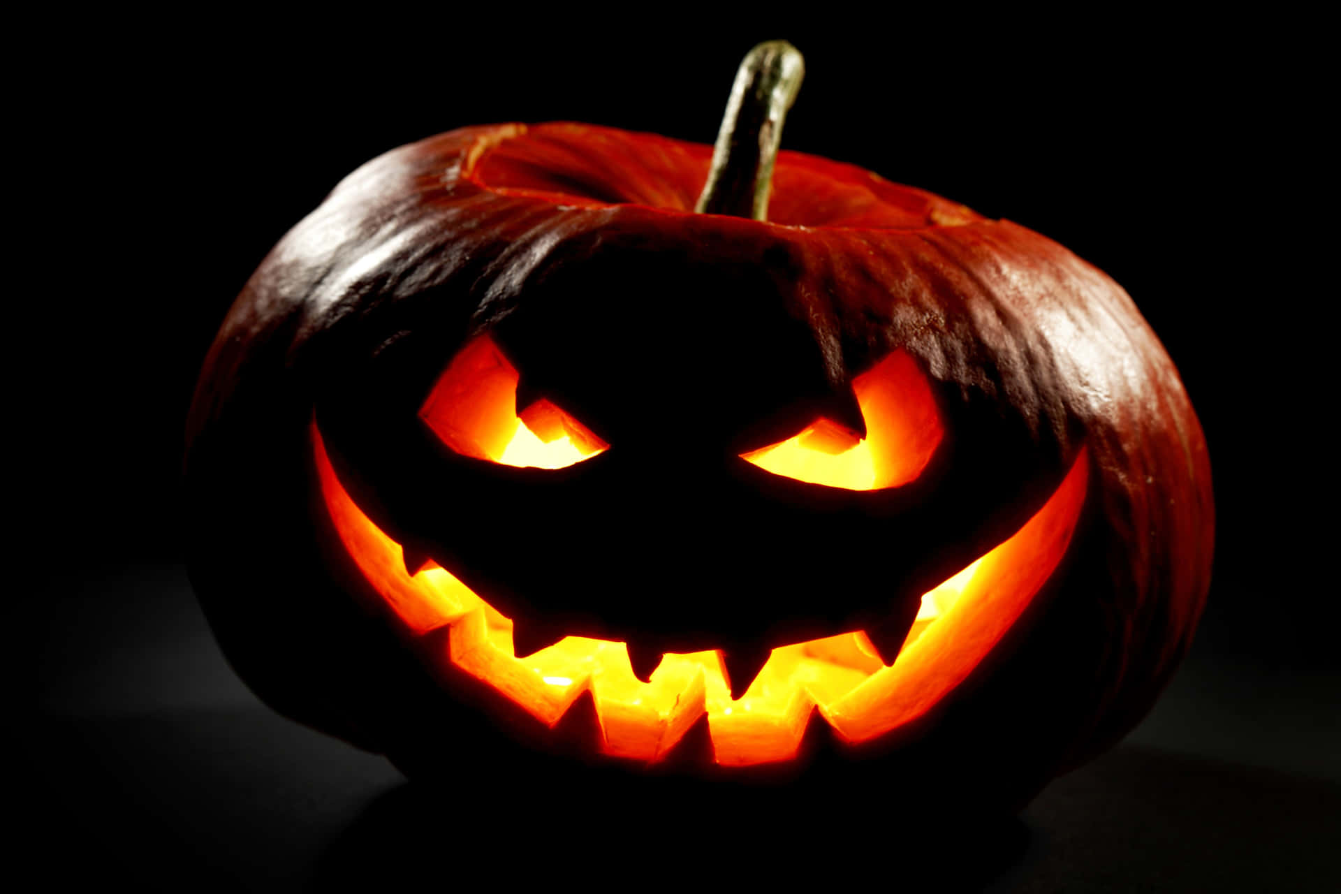 Glowing Jack O Lanternin Darkness Background