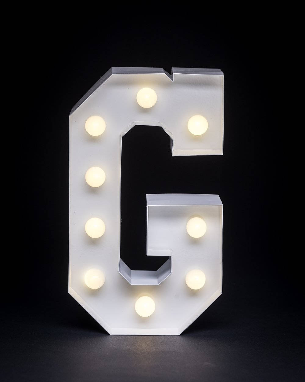 Glowing Letter G With Warm White Lights Background