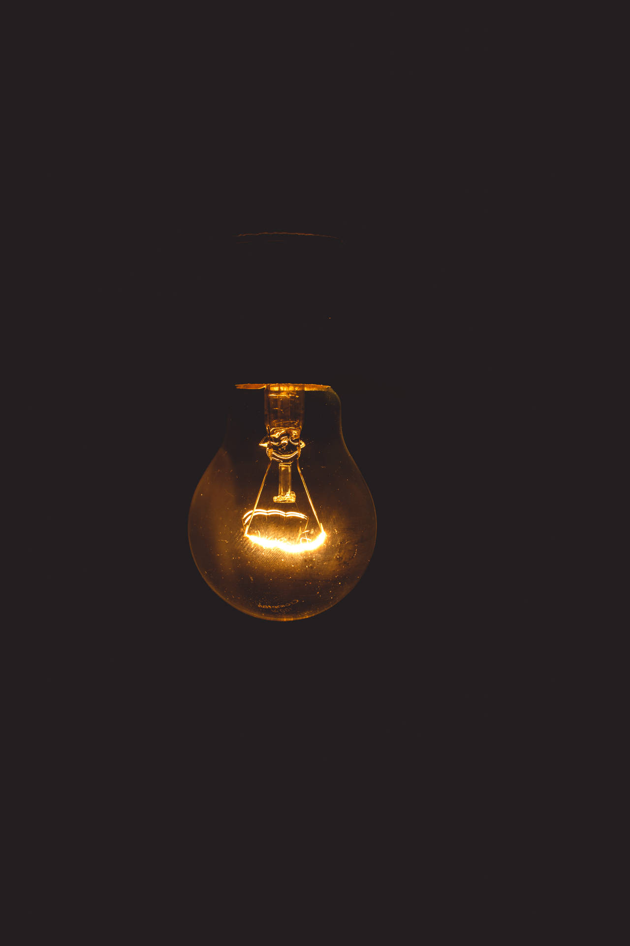 Glowing Light Bulb In Darkness - Symbol Of Wisdom Background