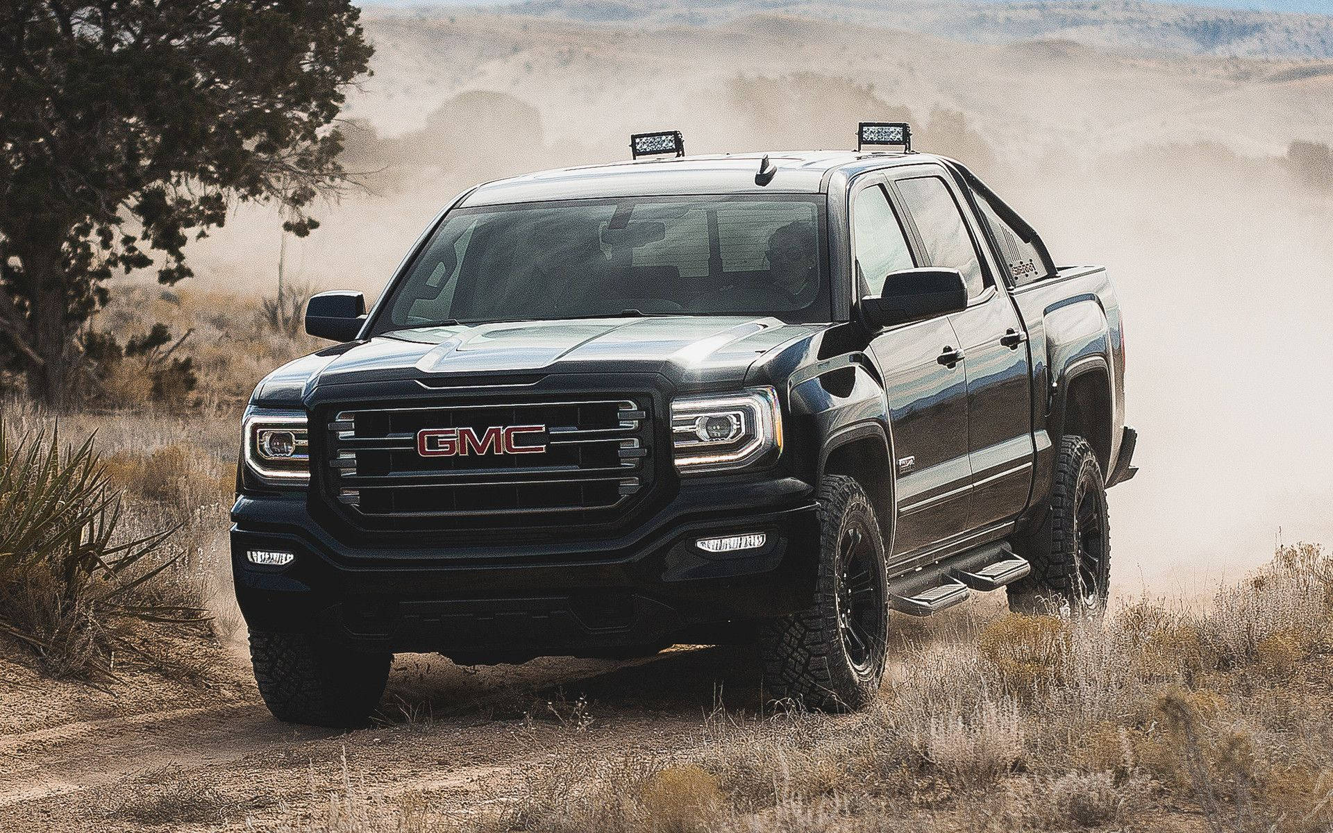 Gmc In A Sandy Area Background