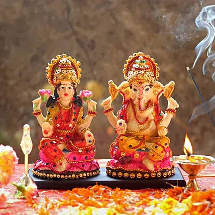 Goddess Lakshmi And Lord Ganesh Figures Background