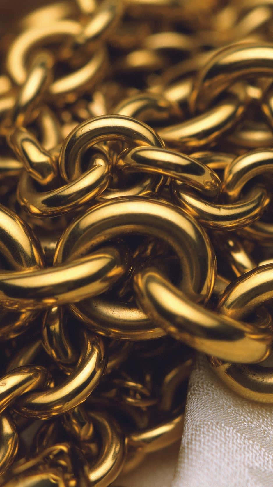 Gold Chain On A White Cloth Background