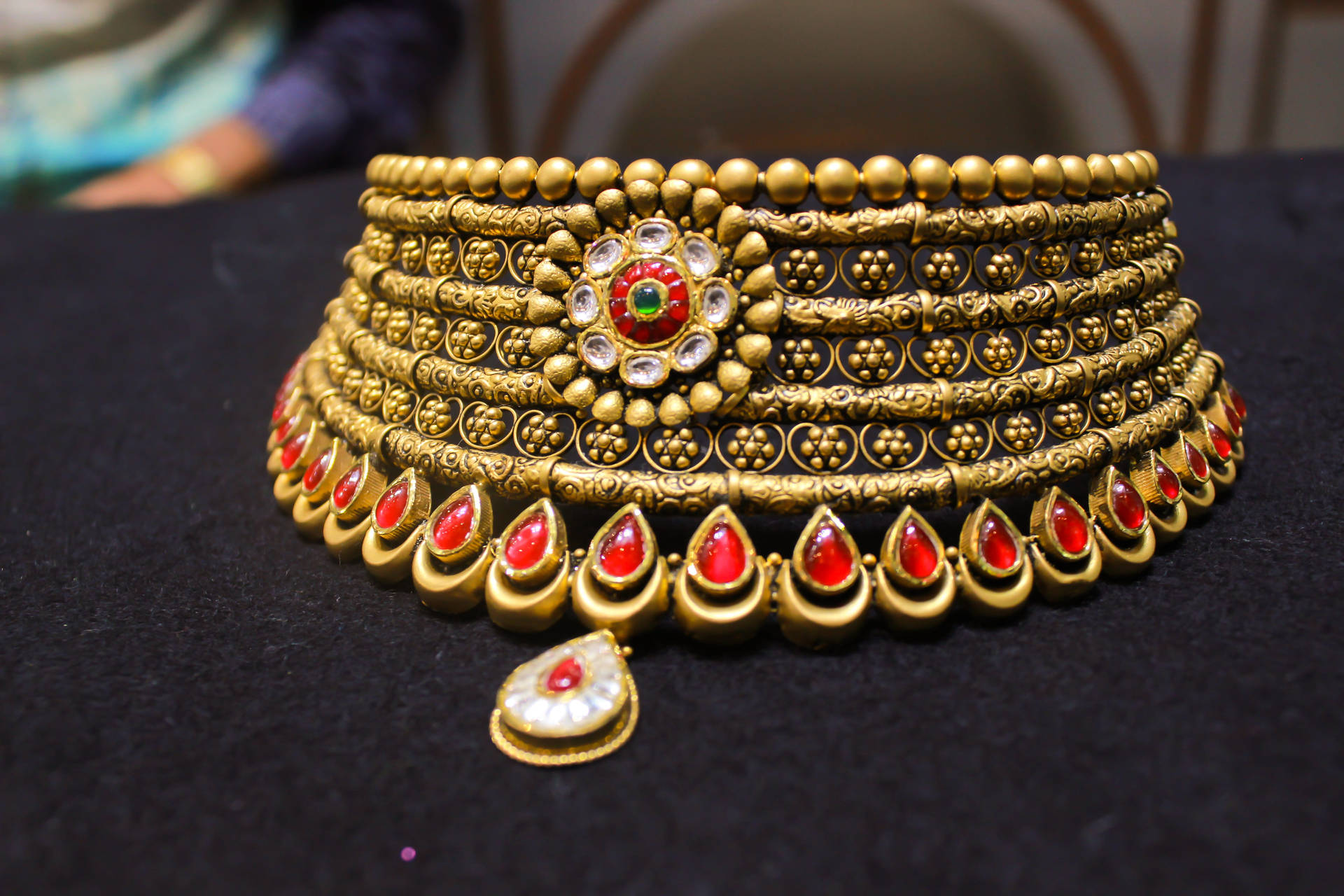 Gold Jewellery With Red Stones Background