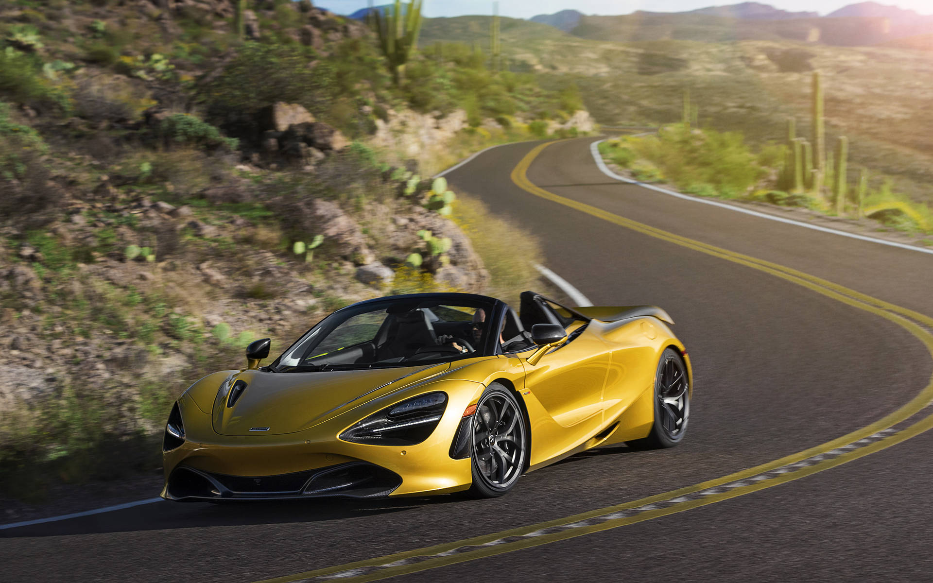 Gold Mclaren Spyder At Winding Road Background