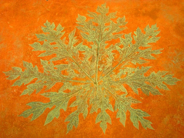 Gold Texture Leaf Against Orange Background