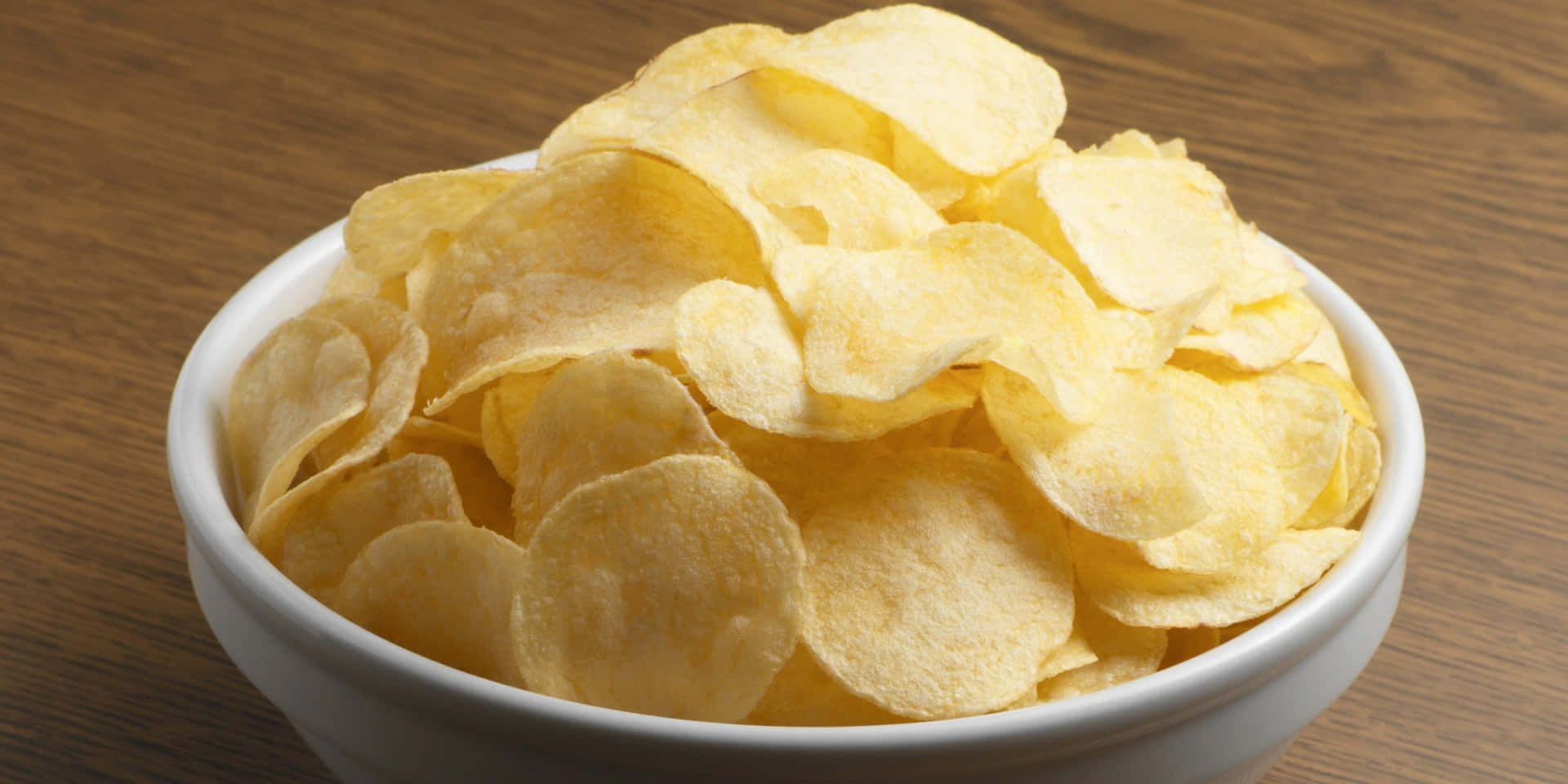 Golden Chips In White Bowl Background