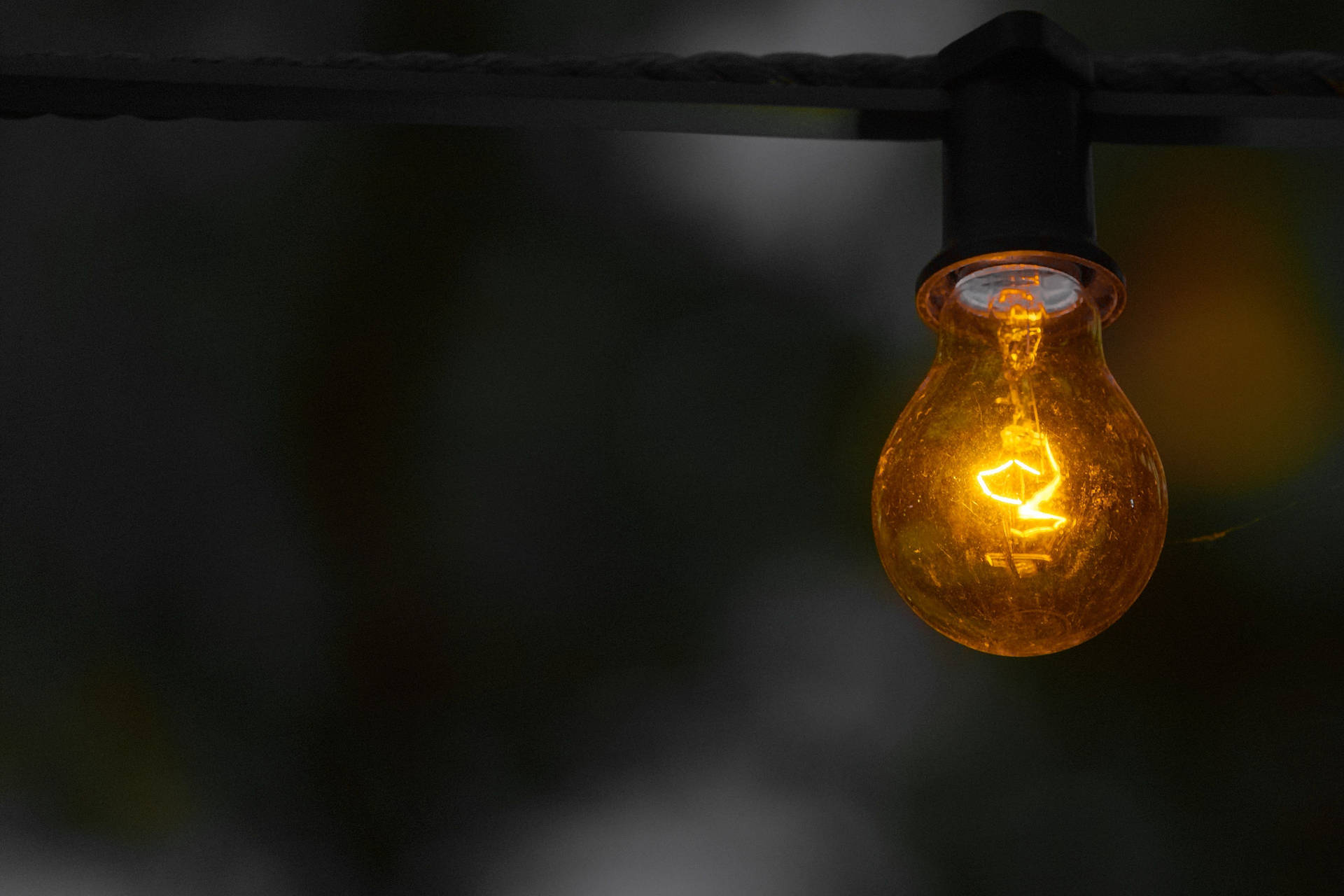Golden Electricity Powered Light Bulb Background