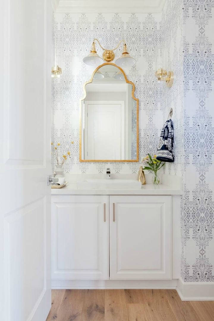 Golden Frame Mirror In A Boho Beachside Bathroom Background