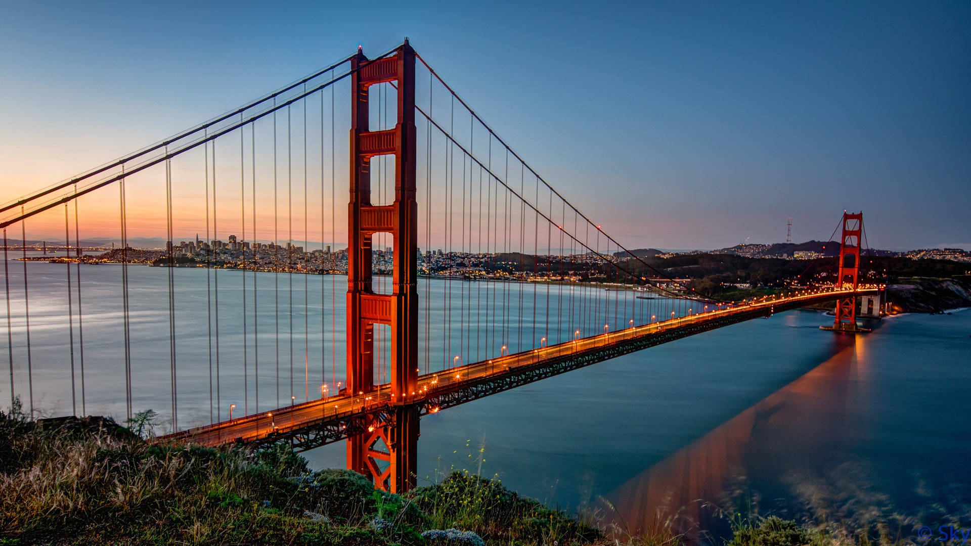 Golden Gate Bridge Orange-tinged Sky Background