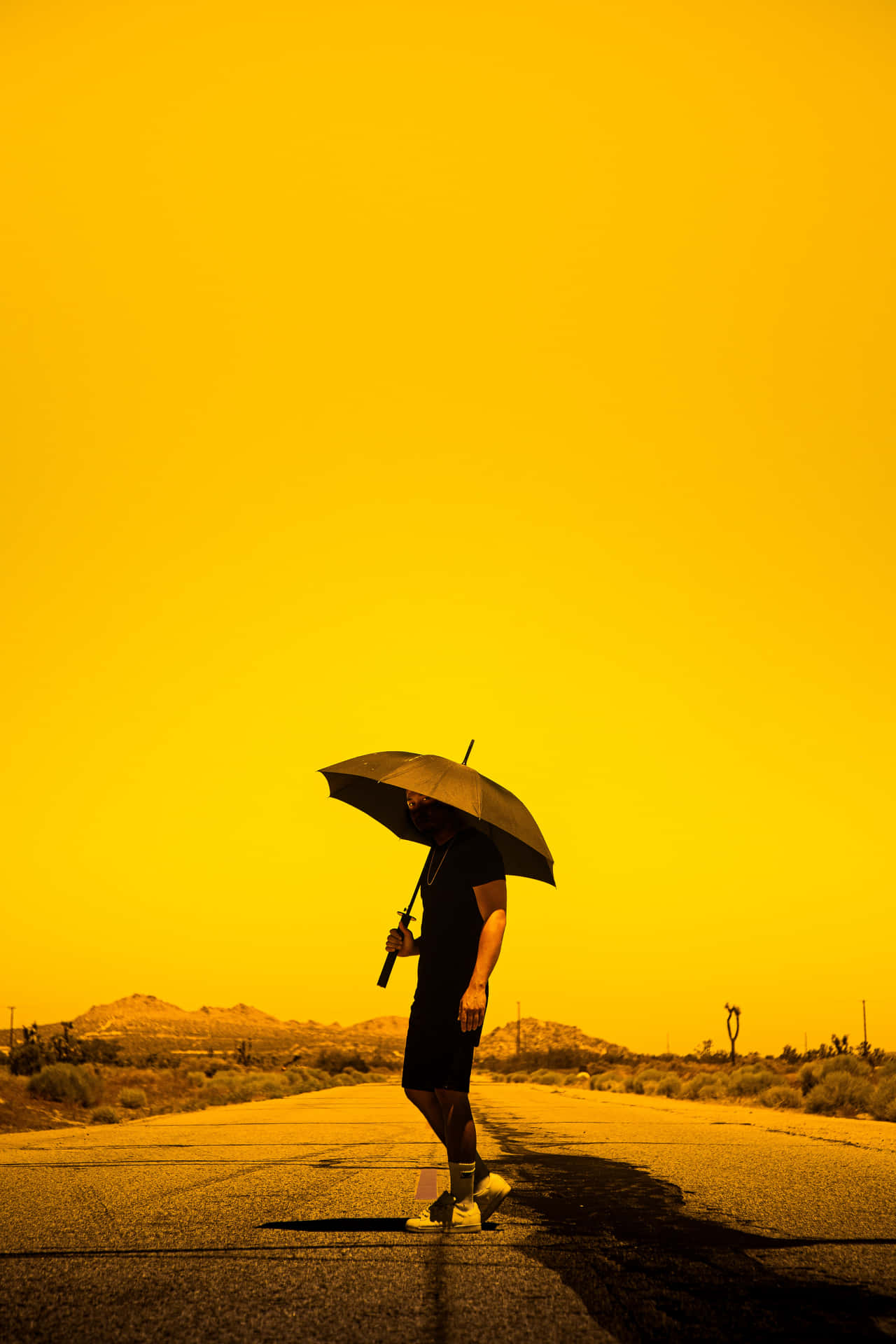 Golden Hued Desert Umbrella Walk Background