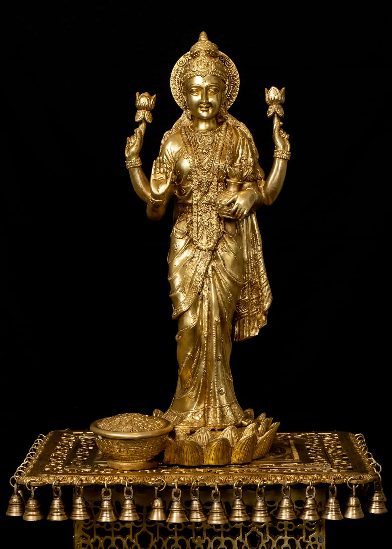 Golden Lakshmi Statueon Pedestal Background