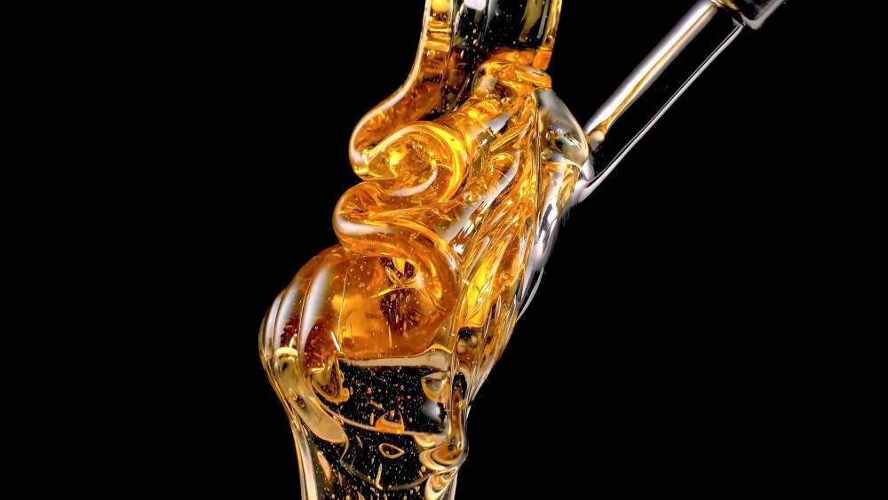 Golden Liquid Delight - A Close-up View Of Honey Background