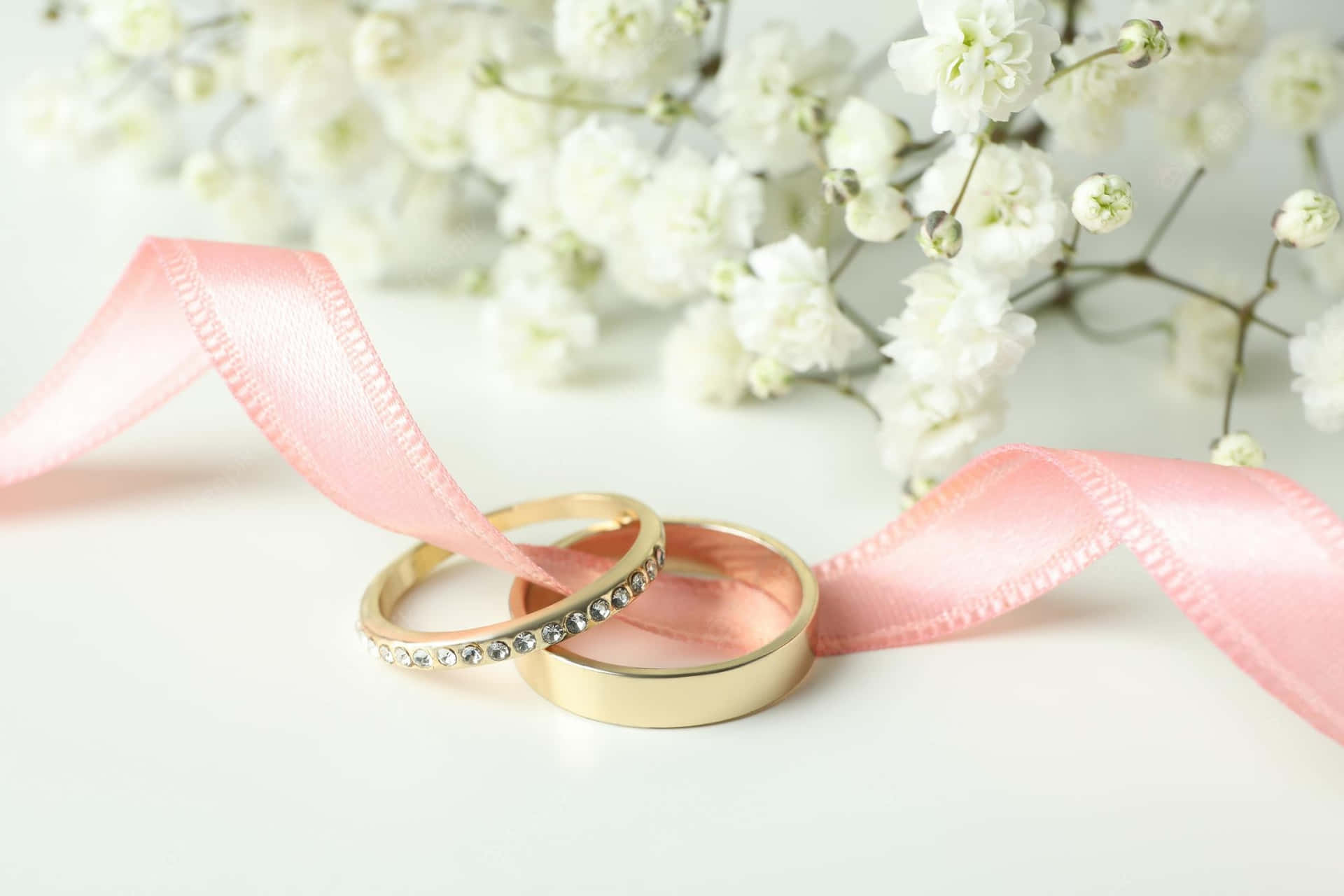 Golden Rings With Pink Ribbon Wedding Background Background