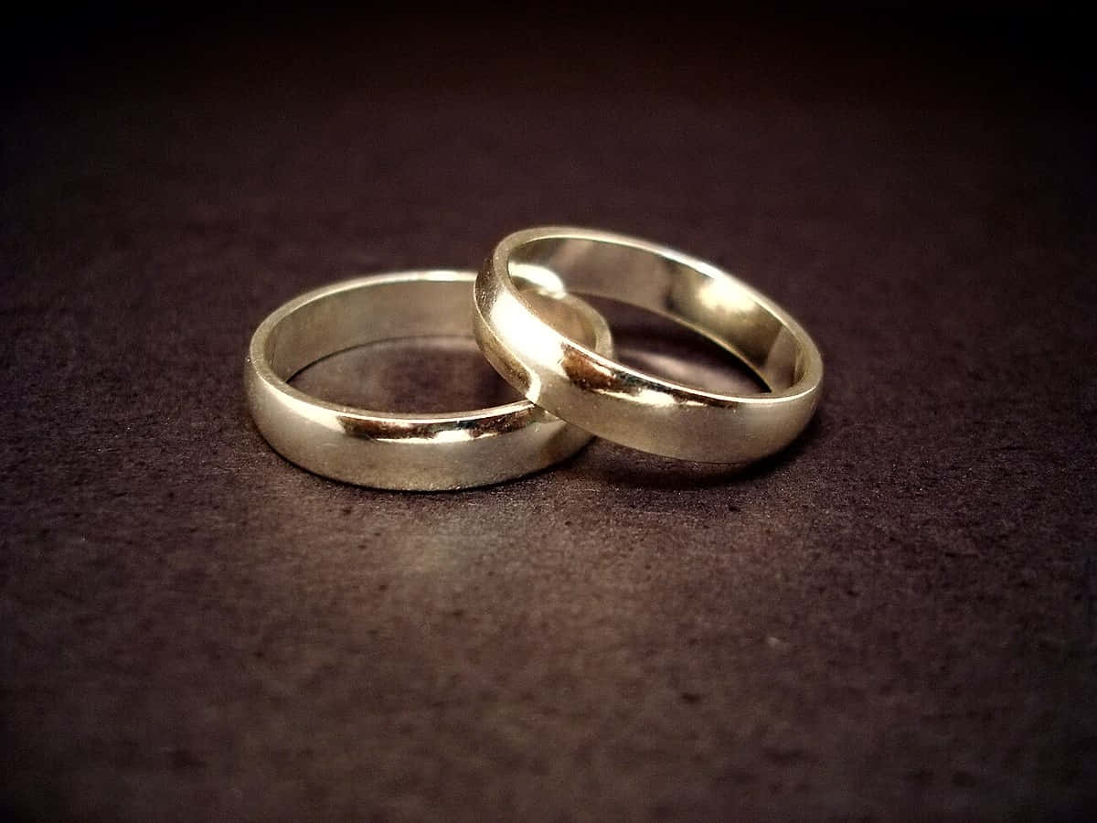 Golden Wedding Ring On Textured Surface Background