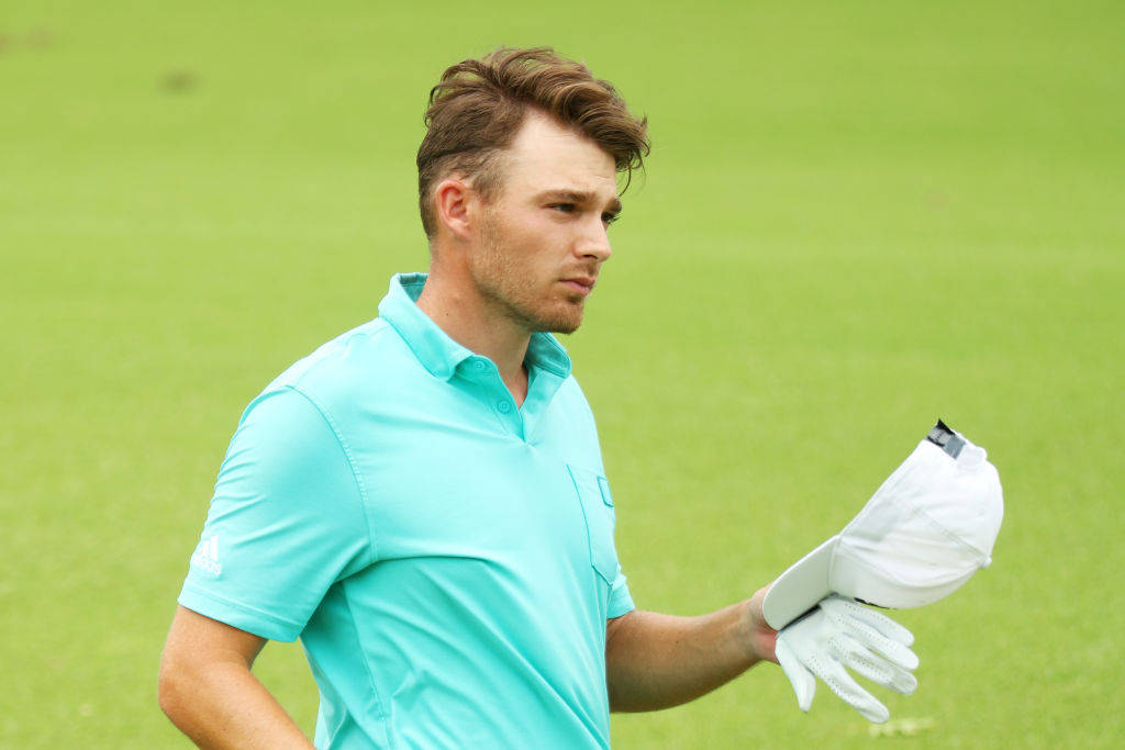 Golfer Aaron Wise Removing His White Cap Background