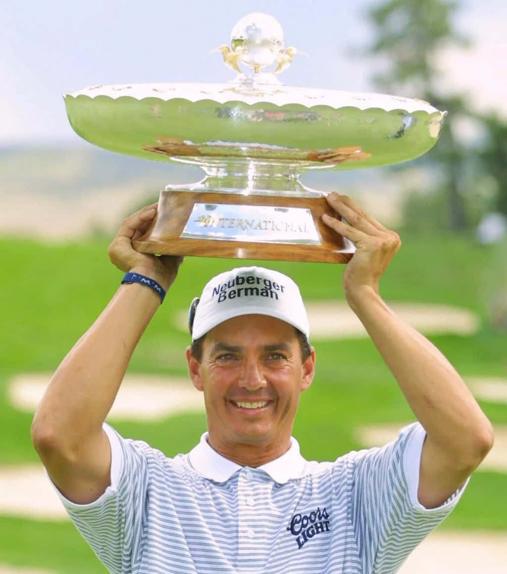 Golfer Celebrating Victorywith Trophy Background