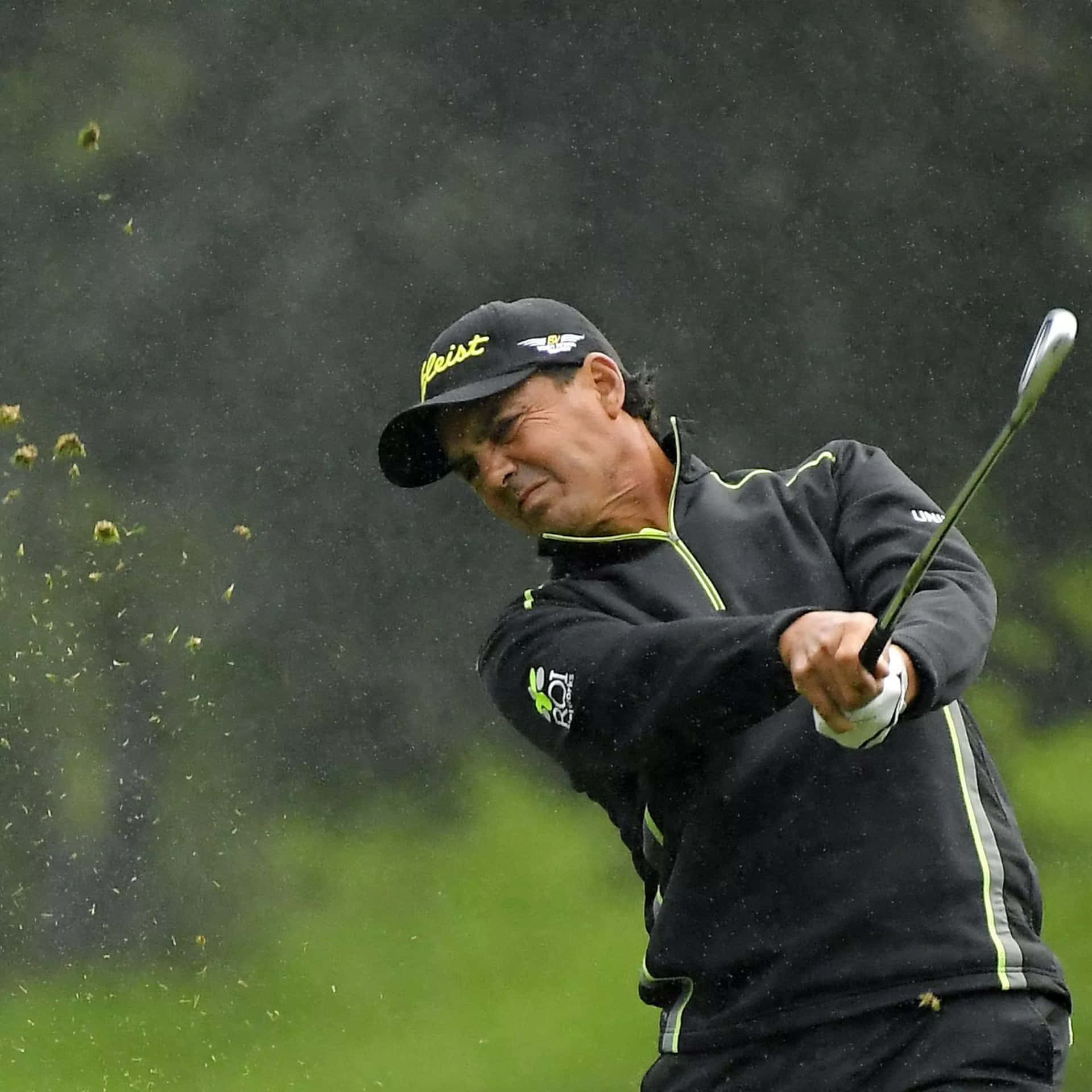 Golfer In Action During Rainy Day Background